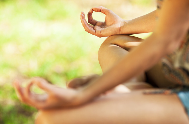 Young female meditate in nature.Close-up image.